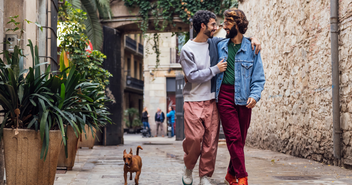 Image of an LGBTQ+ couple actively packing their belongings together. Their shared activity and positive expressions symbolize the exciting first step towards cohabitation, marking a significant milestone in their relationship.