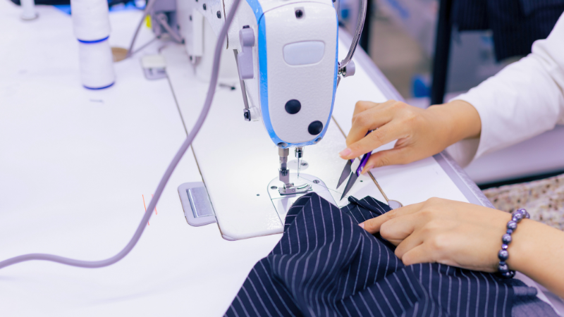 A person is working on fabric on a sewing machine