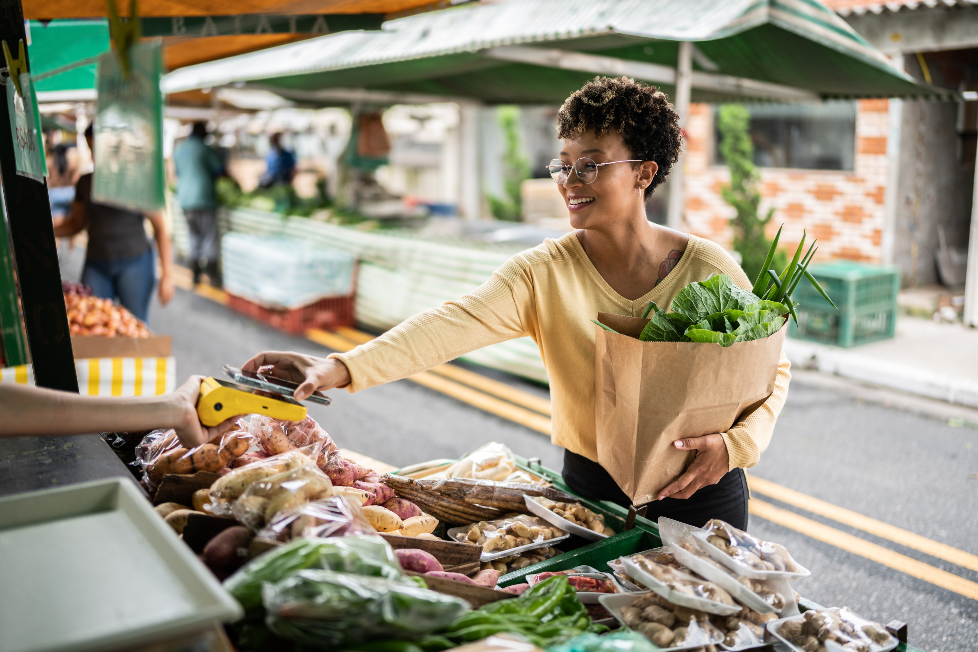 Woman paying for produce at street market