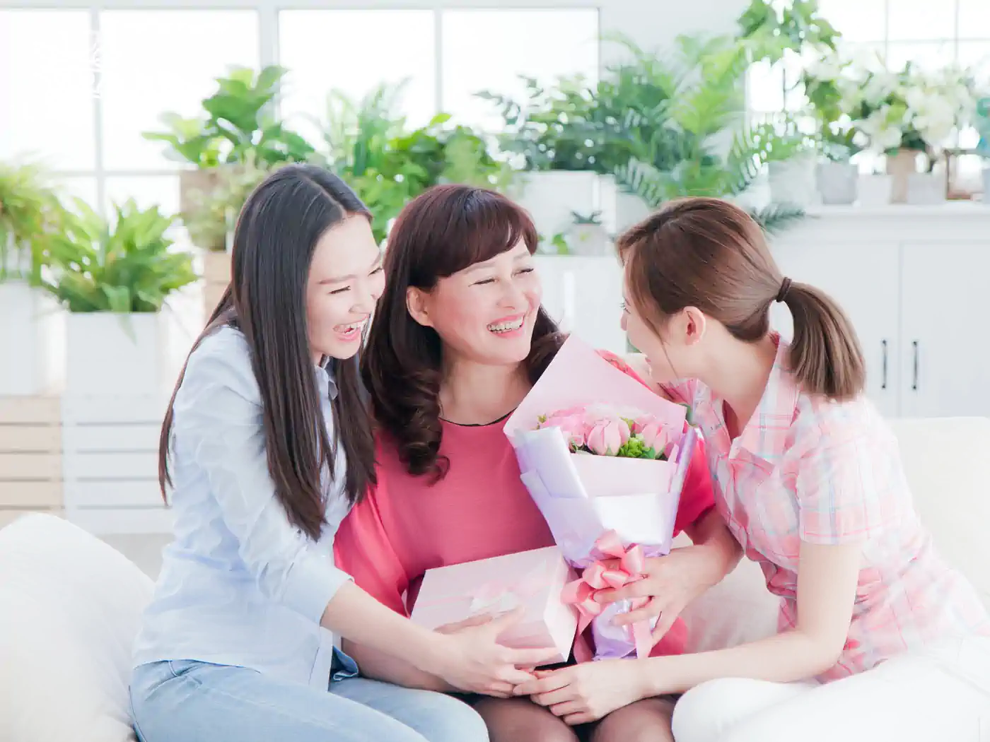 A cheerful image of a family gathered together, presenting a bouquet of flowers as a token of affection and celebration. Fabulous Flowers and Gifts.