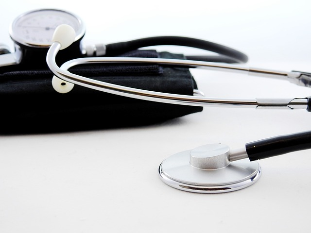 An image of a blood pressure cuff and stethoscope laying on a table.