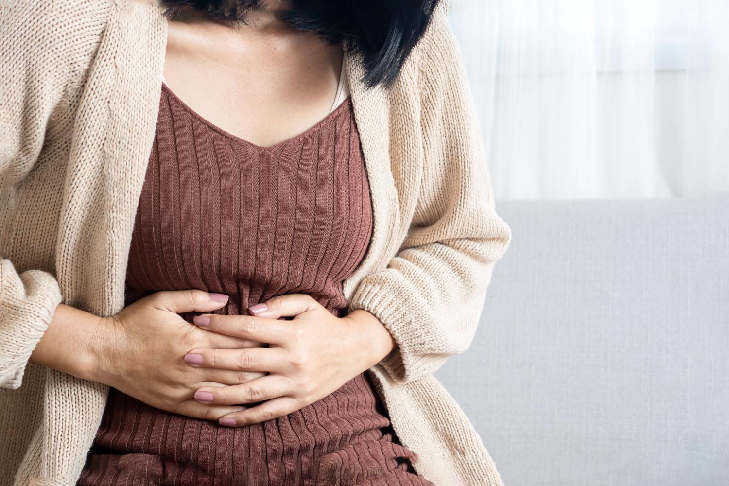 Person holding stomach.