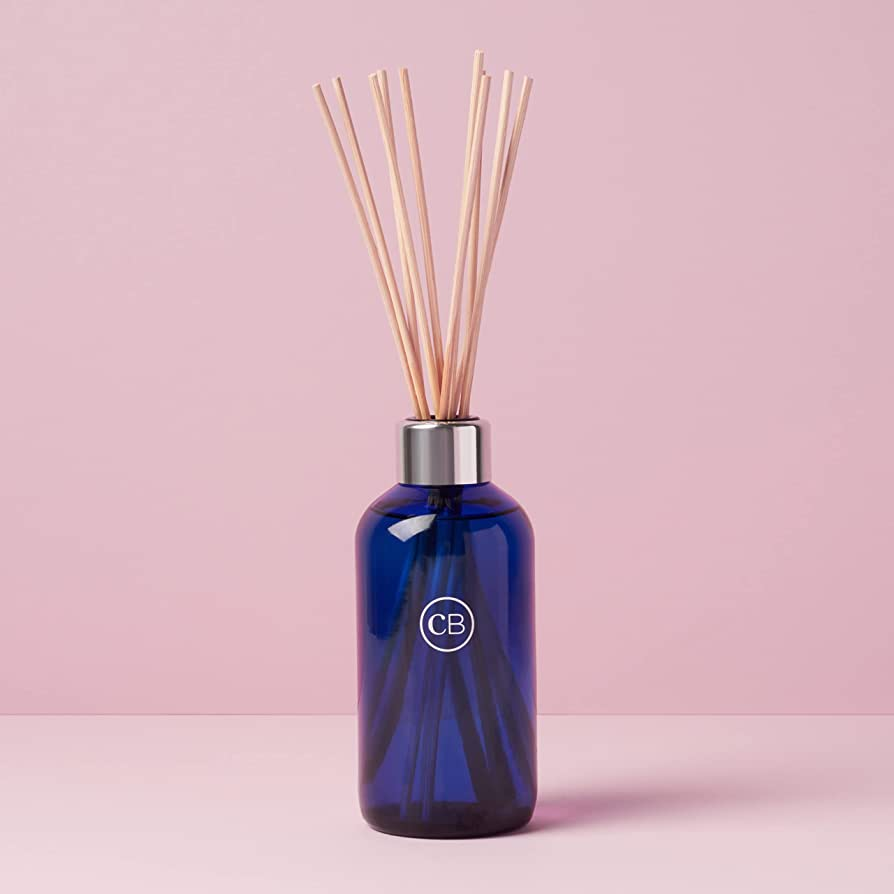 Capri Blue Volcano Reed Diffuser on a pastel pink background.