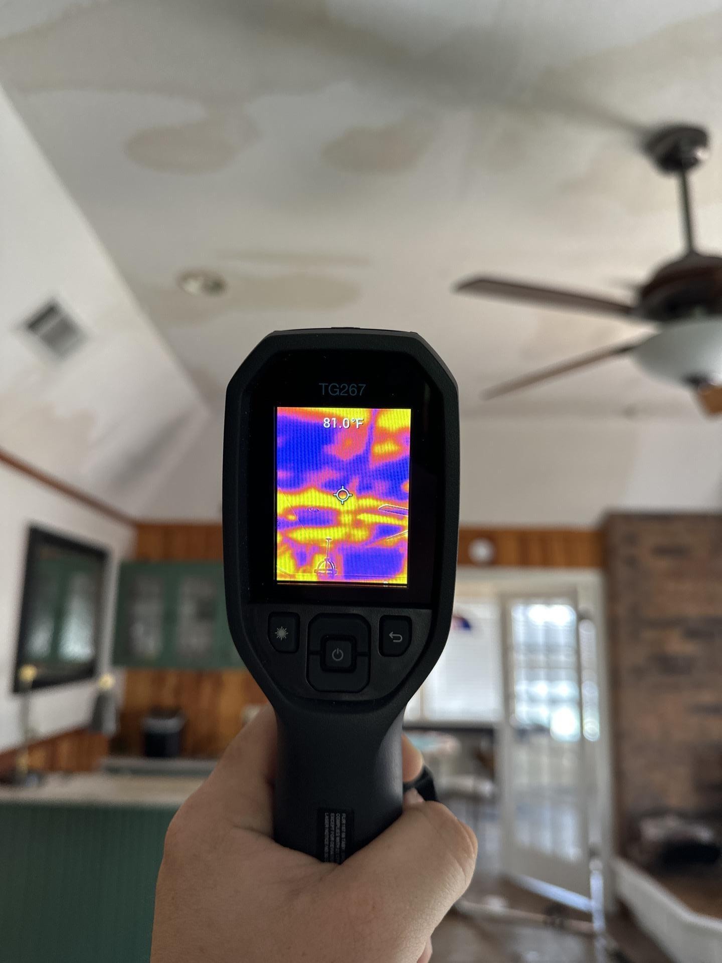 A restoration professional is using thermal imaging equipment to inspect a wall for potential water damage, which may be caused by issues like leaking plumbing or a burst pipe. This assessment is crucial for homeowners to determine the extent of damage and guide the claims process with their insurance company.