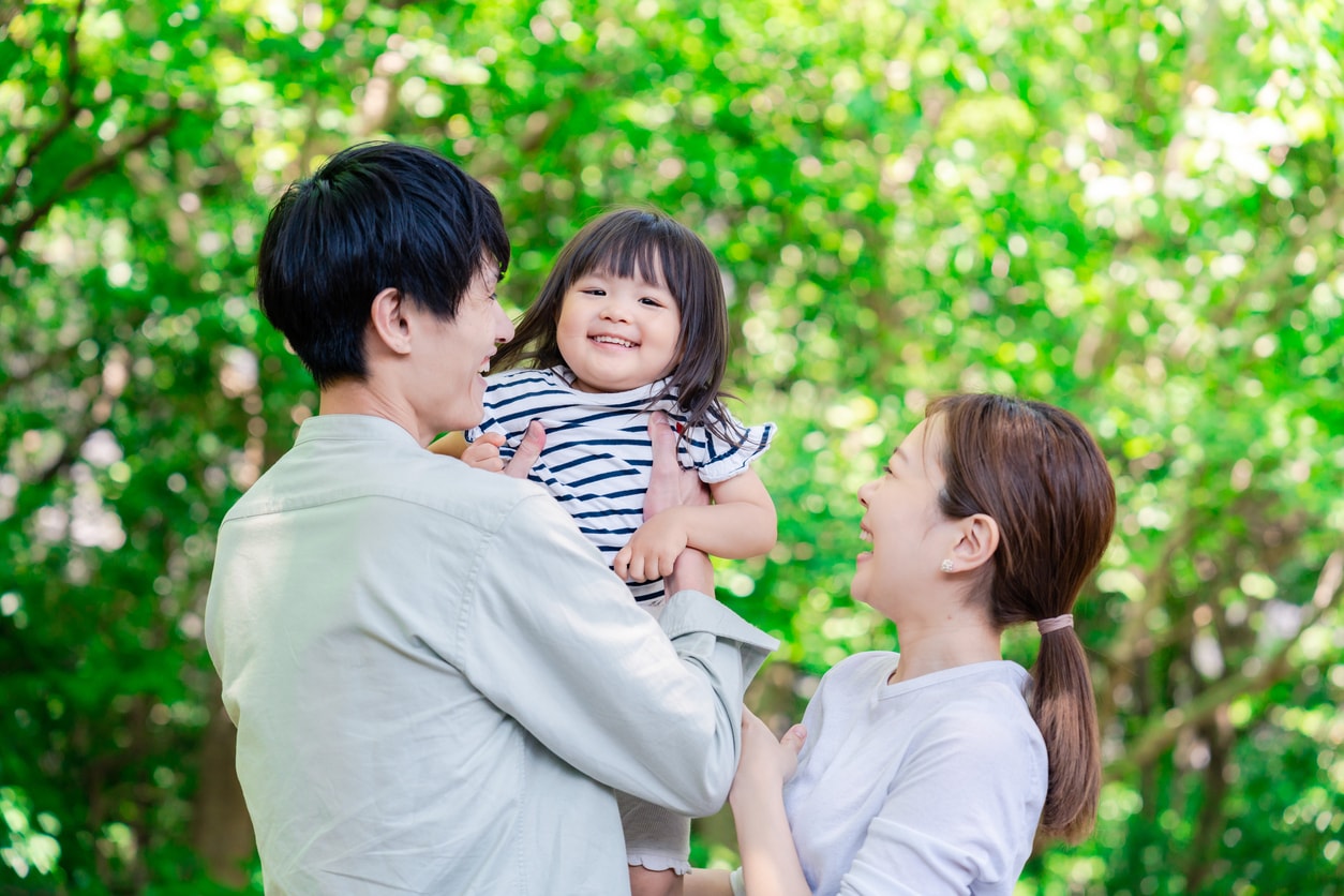 Happy parents playing with their little girl. 