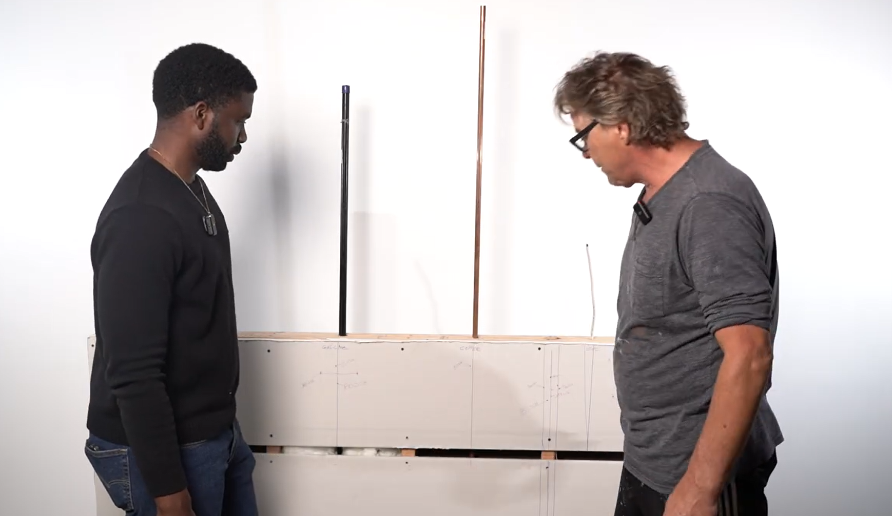 handyman showing how the mock wall was created