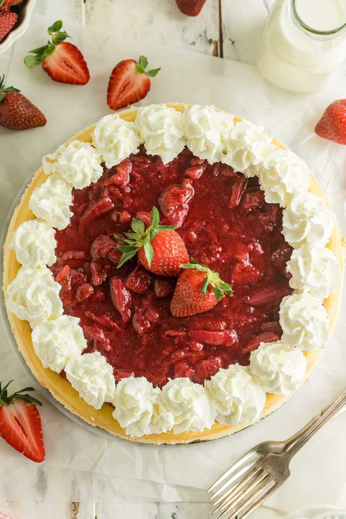 whole strawberry cheesecake topped with whipped cream
