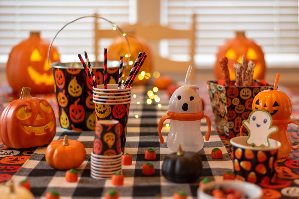 Colorful painted pumpkins arranged as part of Halloween decorations.