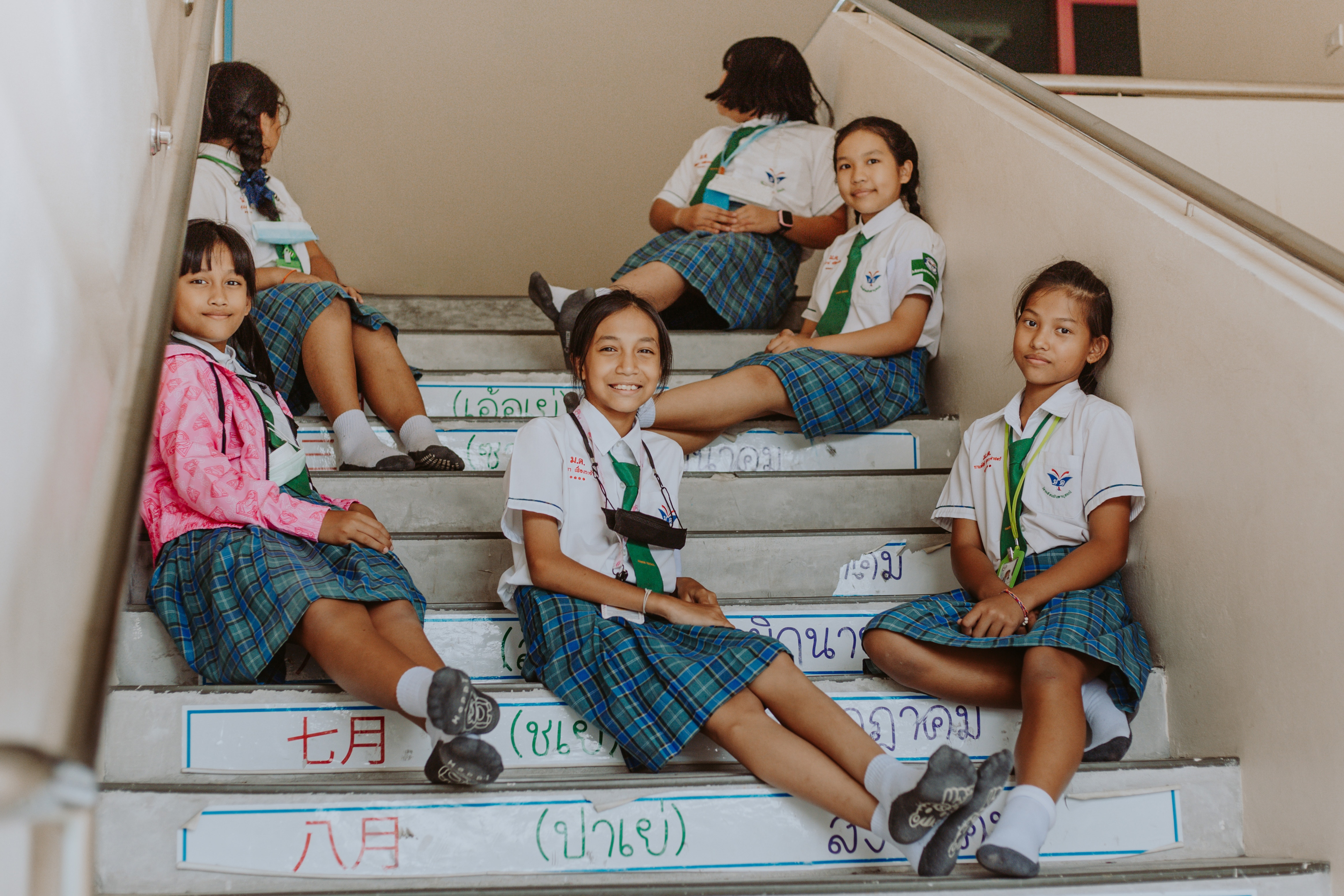 https://www.pexels.com/photo/portrait-of-girls-in-school-uniforms-sitting-on-stairs-in-school-10638211/