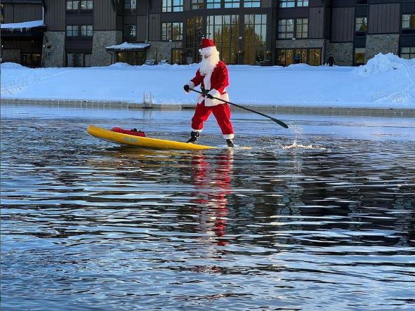 santa claus on a paddle board