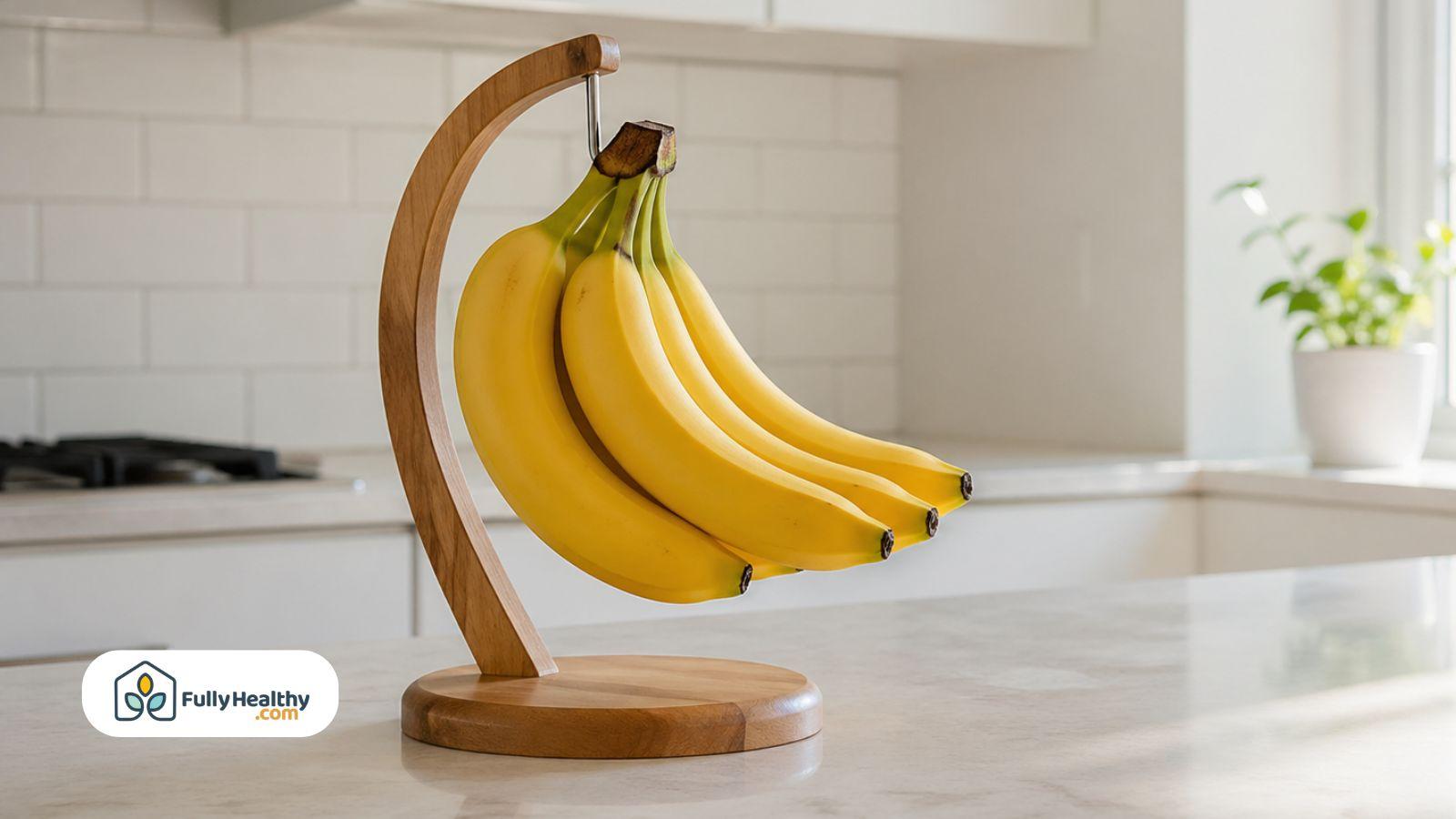 Yellow bananas hanging on wooden stand in bright modern kitchen