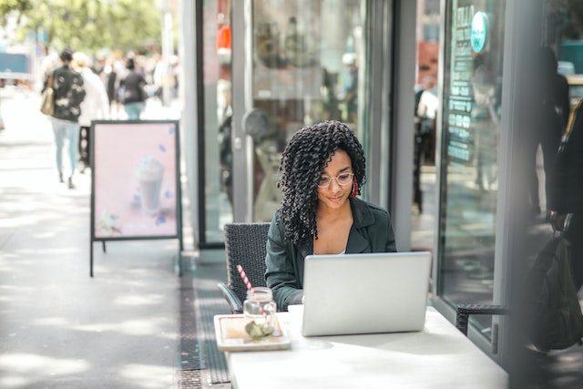 Woman working on laptop outside