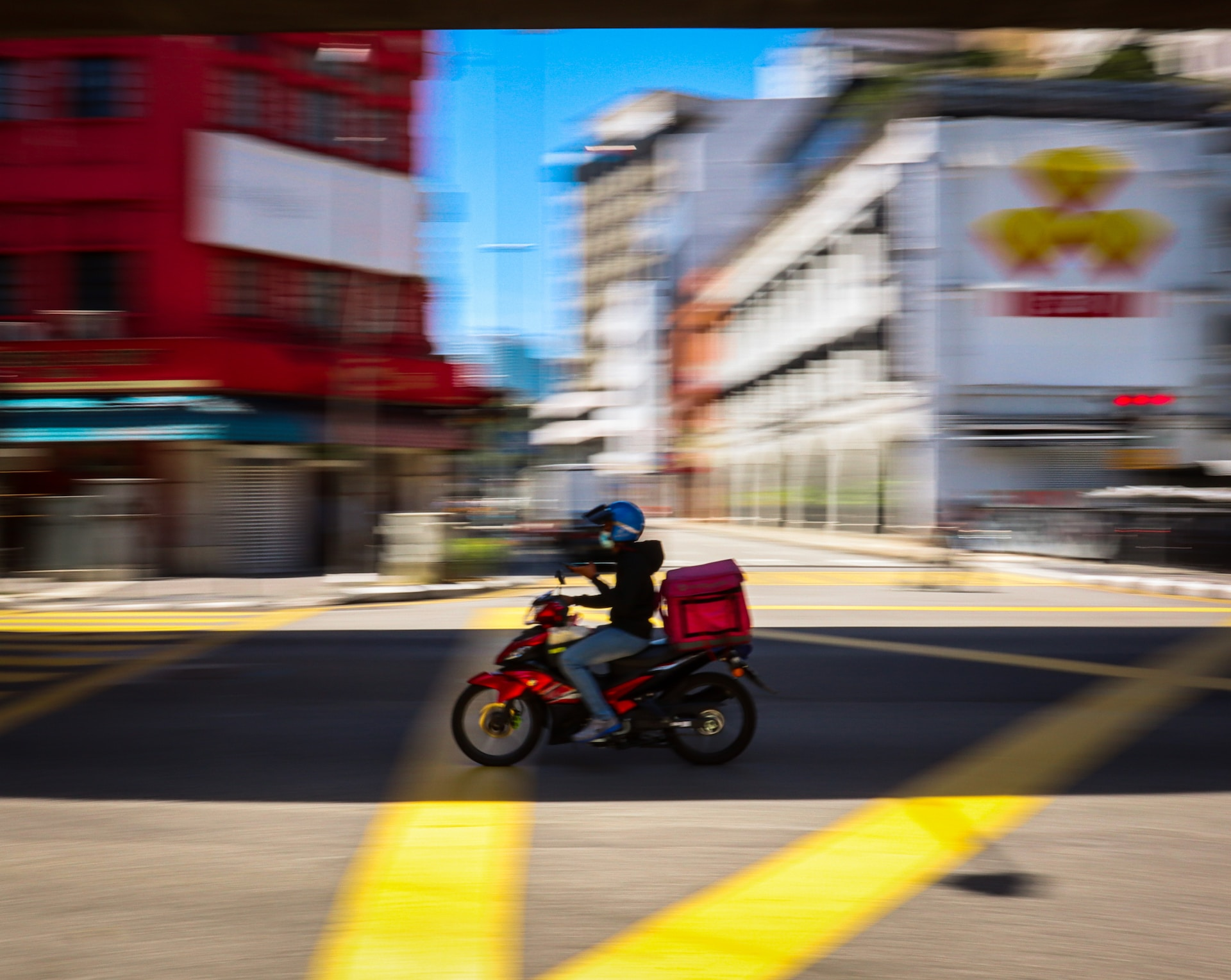 man riding on a red motorcycle on the road in daylight 