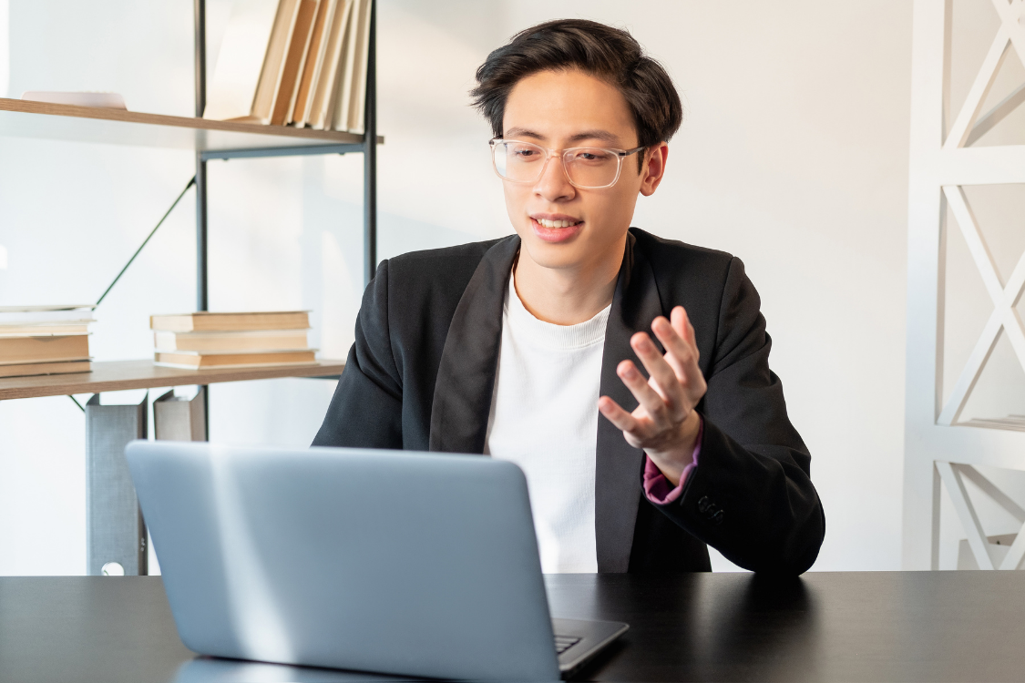 Man in glasses speaking confidently on a video call during a virtual meeting