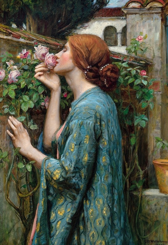 woman smelling fresh roses, including pink and yellow roses