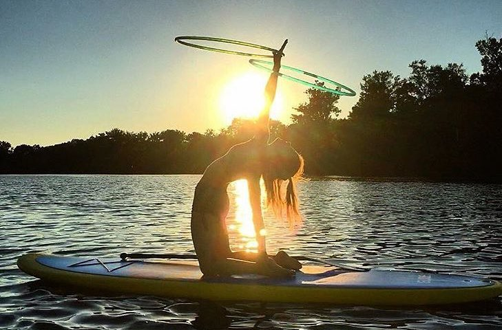 woman kneeling on a paddle board