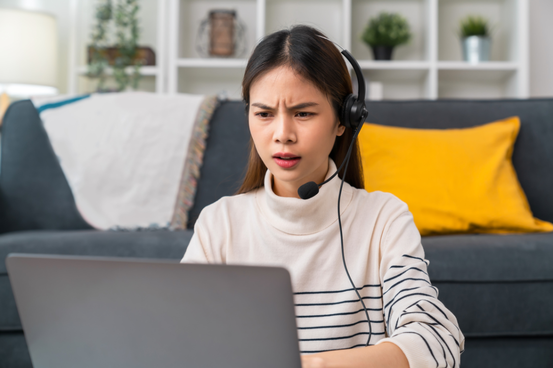 Filipino virtual assistant looking confused during a video call, experiencing communication challenges in a remote work setup