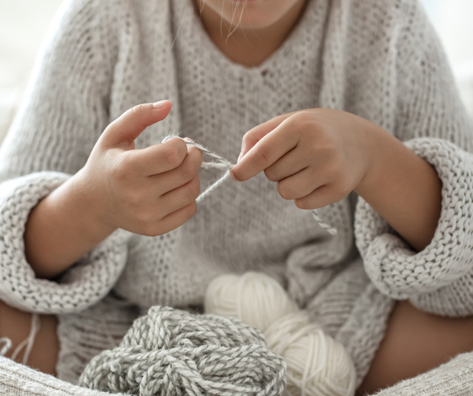 A picture of a person reading crochet pattern instructions and notations