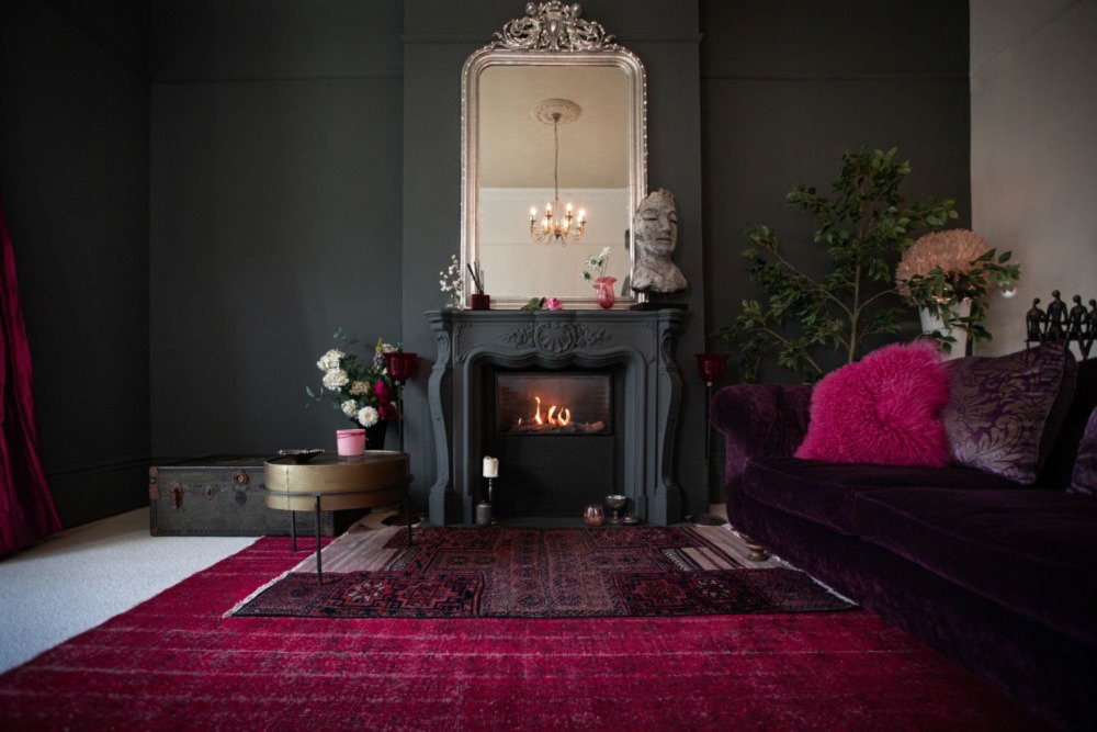 Living room with dark walls and authentic fireplace