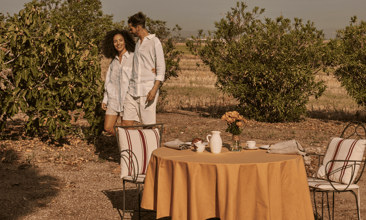 Couple walking on the right path in an open field as they walk towards a dinner table.
