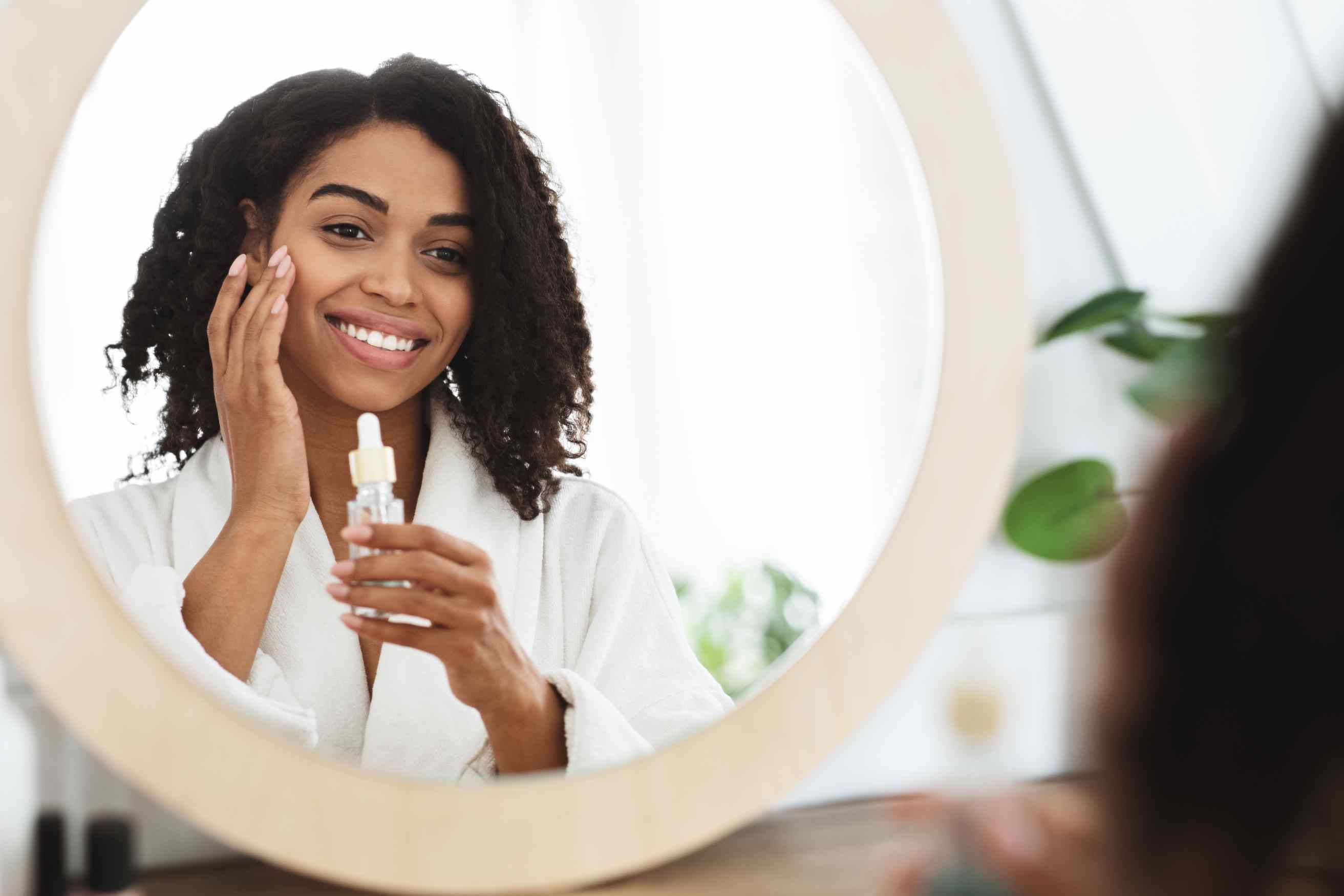 A woman applying essential oils to her face safely