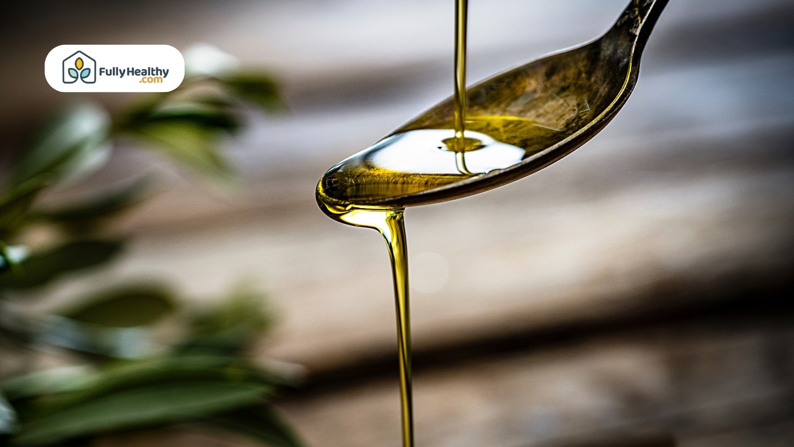 Close-up of olive oil dripping from spoon with blurred background