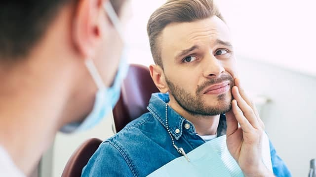 Man Thinking About Dental Costs