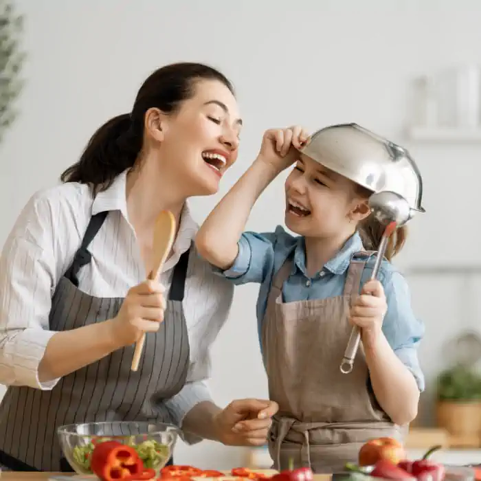 Mother and daughter joyfully cooking together, promoting the CHINAHERB Supplement Collection, available for purchase at The Good Stuff Health Shop South Africa