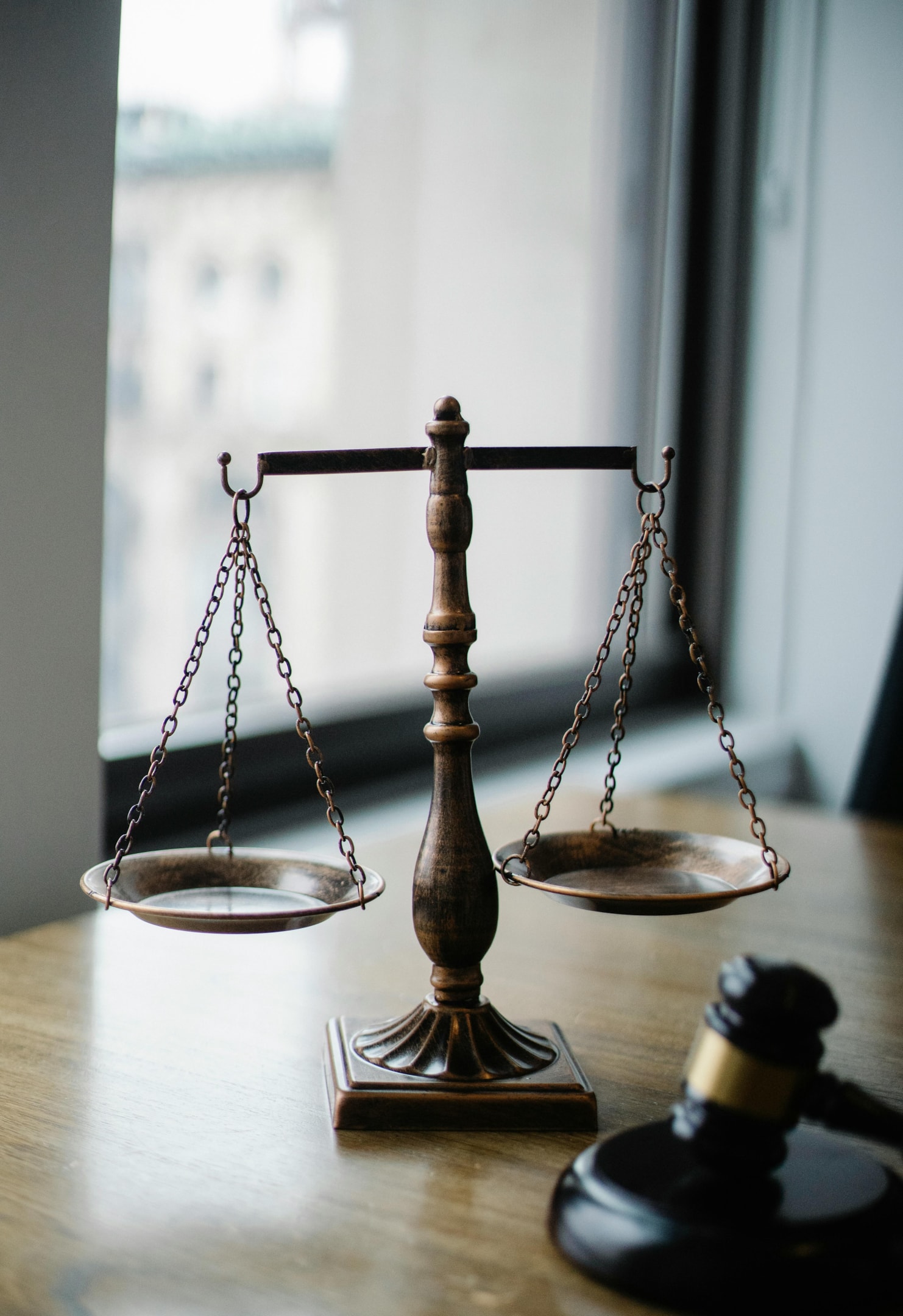 Scales and gavel inside law office, frequented by real estate wholesalers for legal advice.