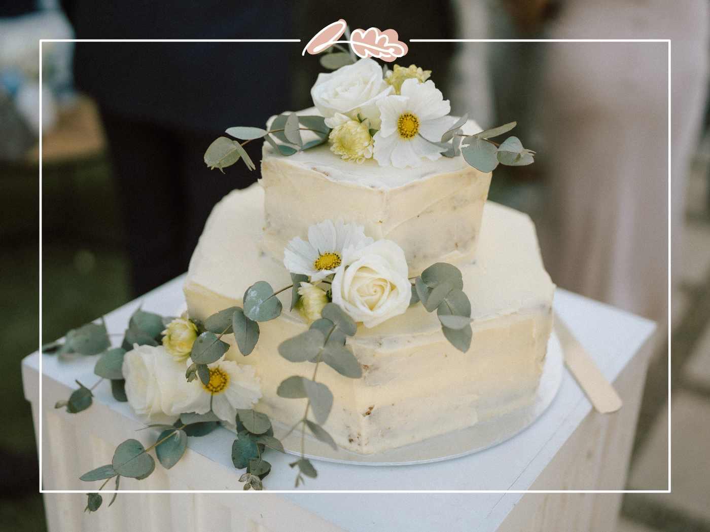 Two-tier white wedding cake topped with white roses, cosmos and eucalyptus at Tess and Greg's Nantes Estate wedding