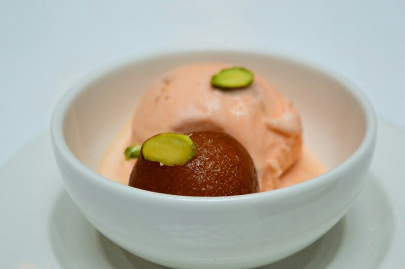 Scoops of creamy ice cream with gulab jamun