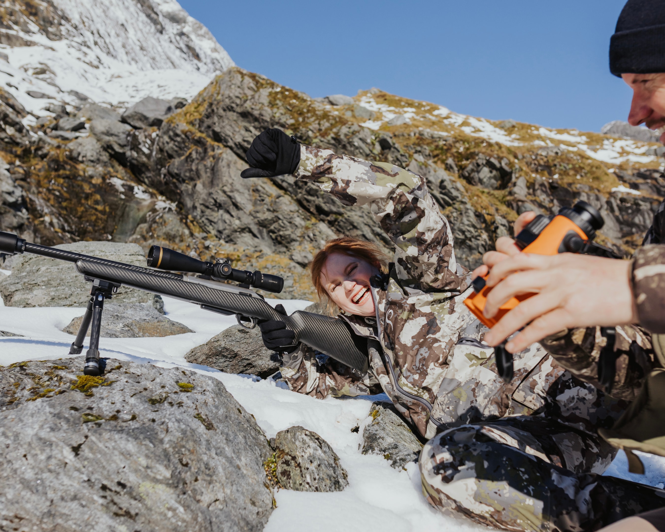 Celebration of successful chamois hunt with rifle in New Zealand.