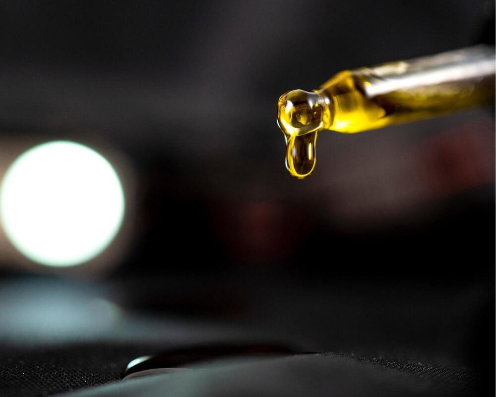 CBD oil dripping from a dropper