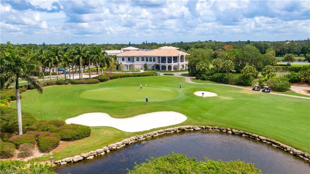 The image depicts the entrance to Imperial Golf Estates, showcasing a gated community with lush, mature landscaping and prominent security features. This inviting access point reflects the serene and upscale atmosphere of this North Naples neighborhood, ideal for golf enthusiasts and residents alike.
