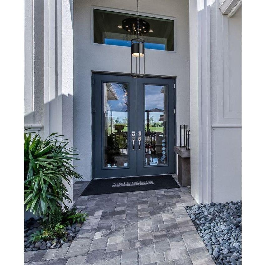 Modern front door with a pendant outdoor light fixture, featuring a sleek design that complements the home's contemporary architecture.