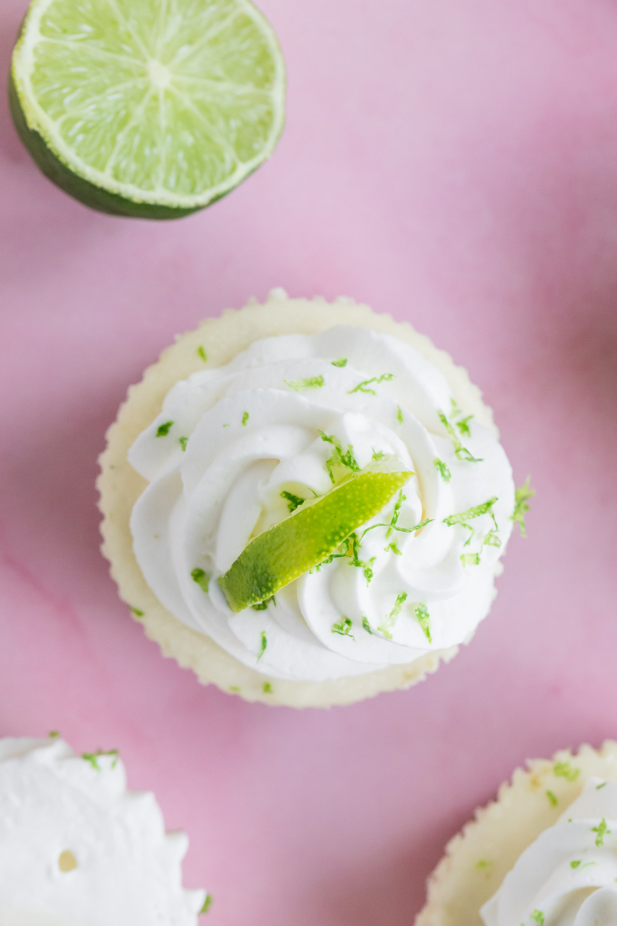 top down view of a mini key lime cheesecake topped with whipped cream
