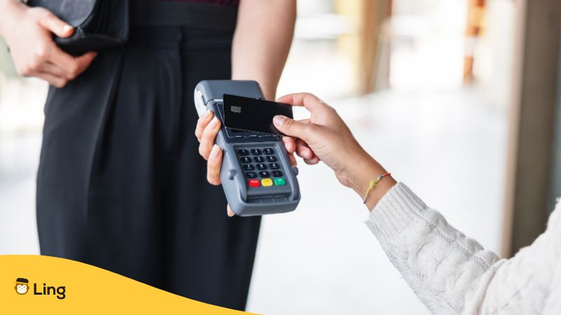 Close Up Of A Woman Paying In A Restaurant With A Credit Card - tamil restaurant vocabulary