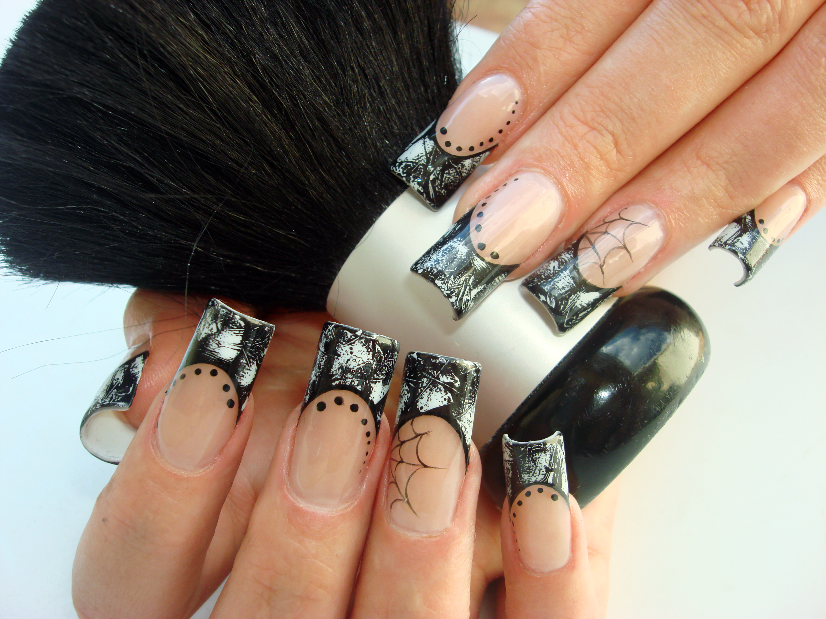 A black french tip manicure with festive winter designs