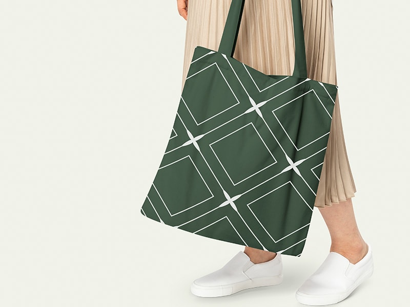 Women carrying printed green cotton tote