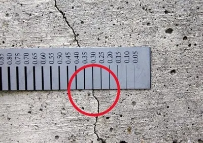 Concrete crack gauge on a cracked concrete surface
