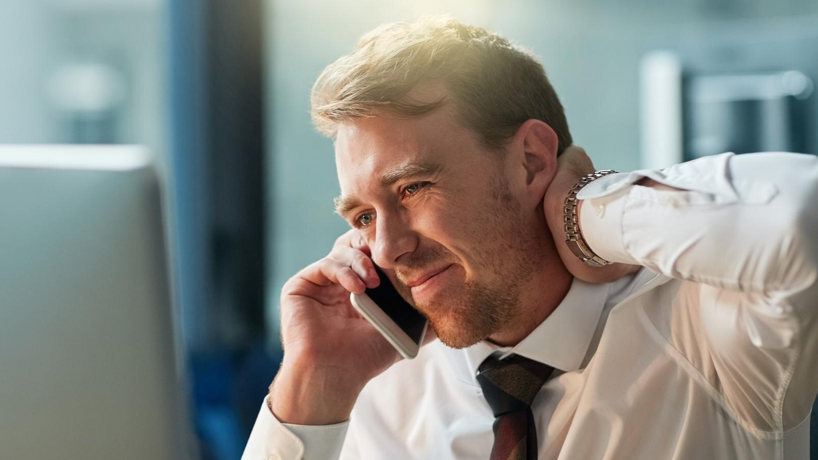 Frustrated employee managing business operations on a call, likely facing performance issues with enterprise telecom solutions.