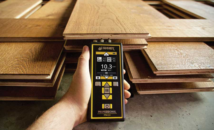 Wooden plank with moisture meter testing the moisture content