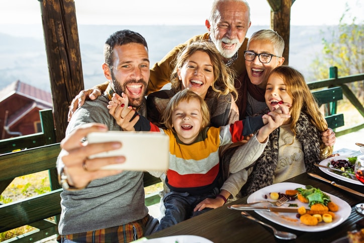 Family smiling for a selfie