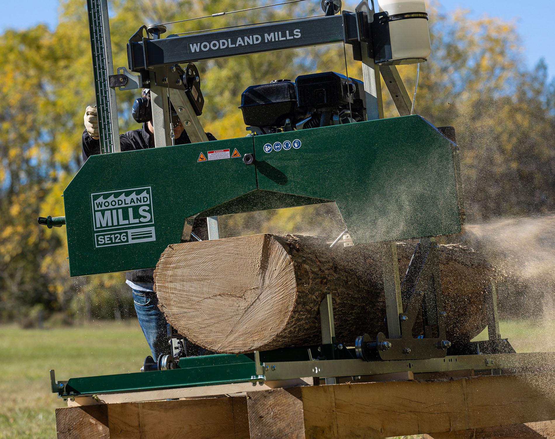 A log being milled on a Woodland Mills SE126 Portable Sawmill.