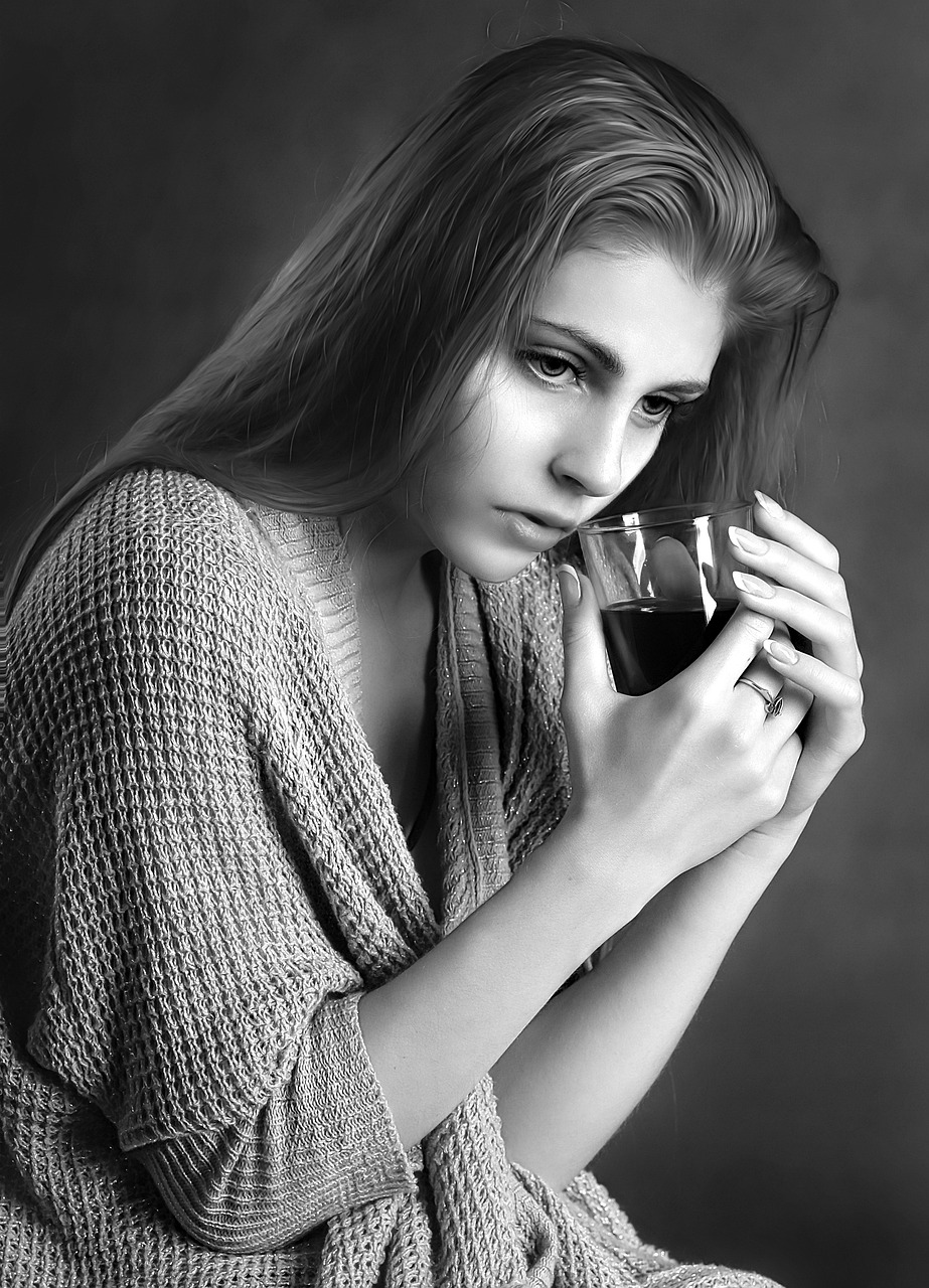 An image of a young woman drinking tea due to sore throat when pregnant. 