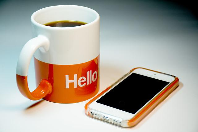 Mobile optimization on smartphone and coffee cup.
