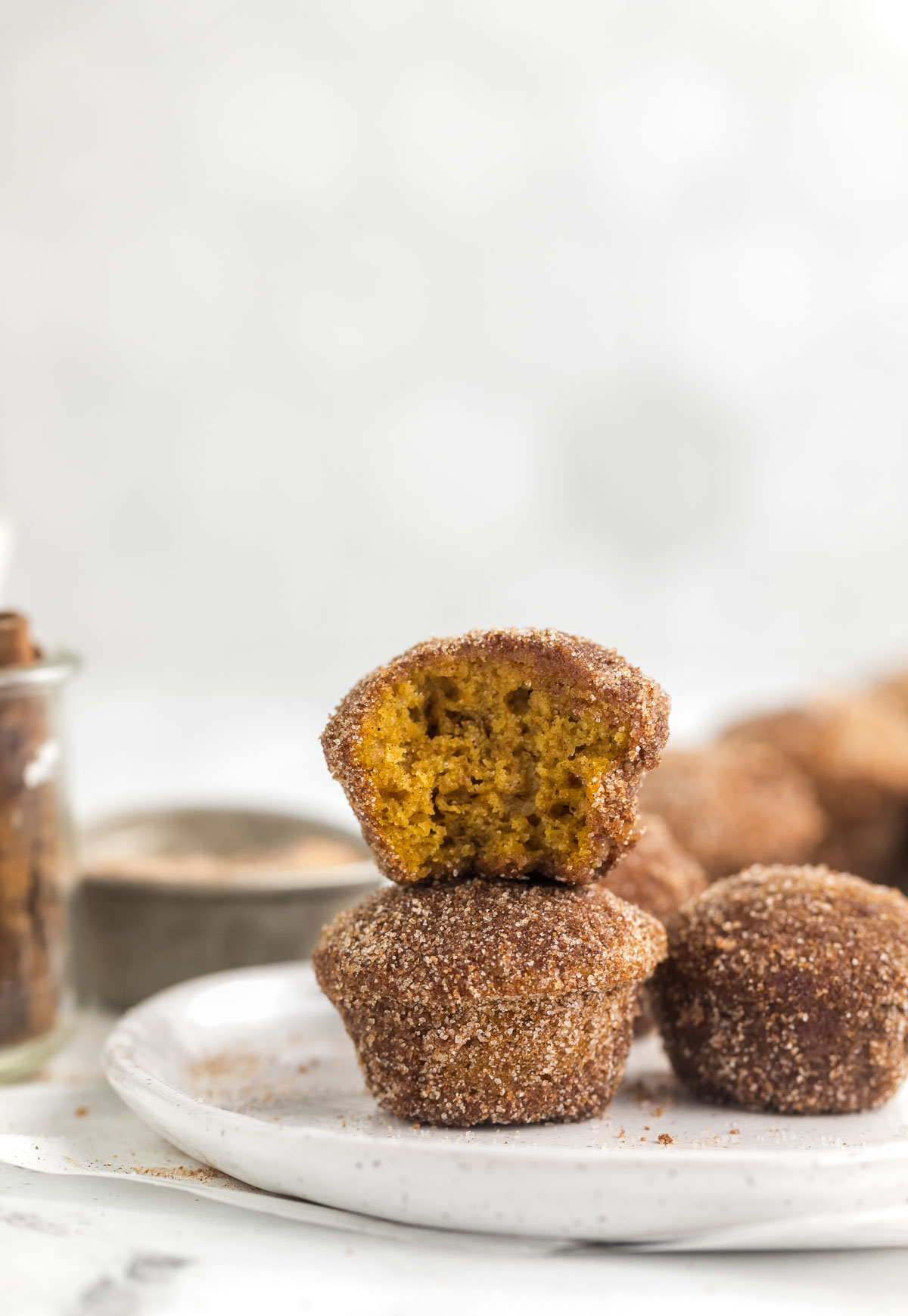 stacked mini pumpkin muffins on a plate
