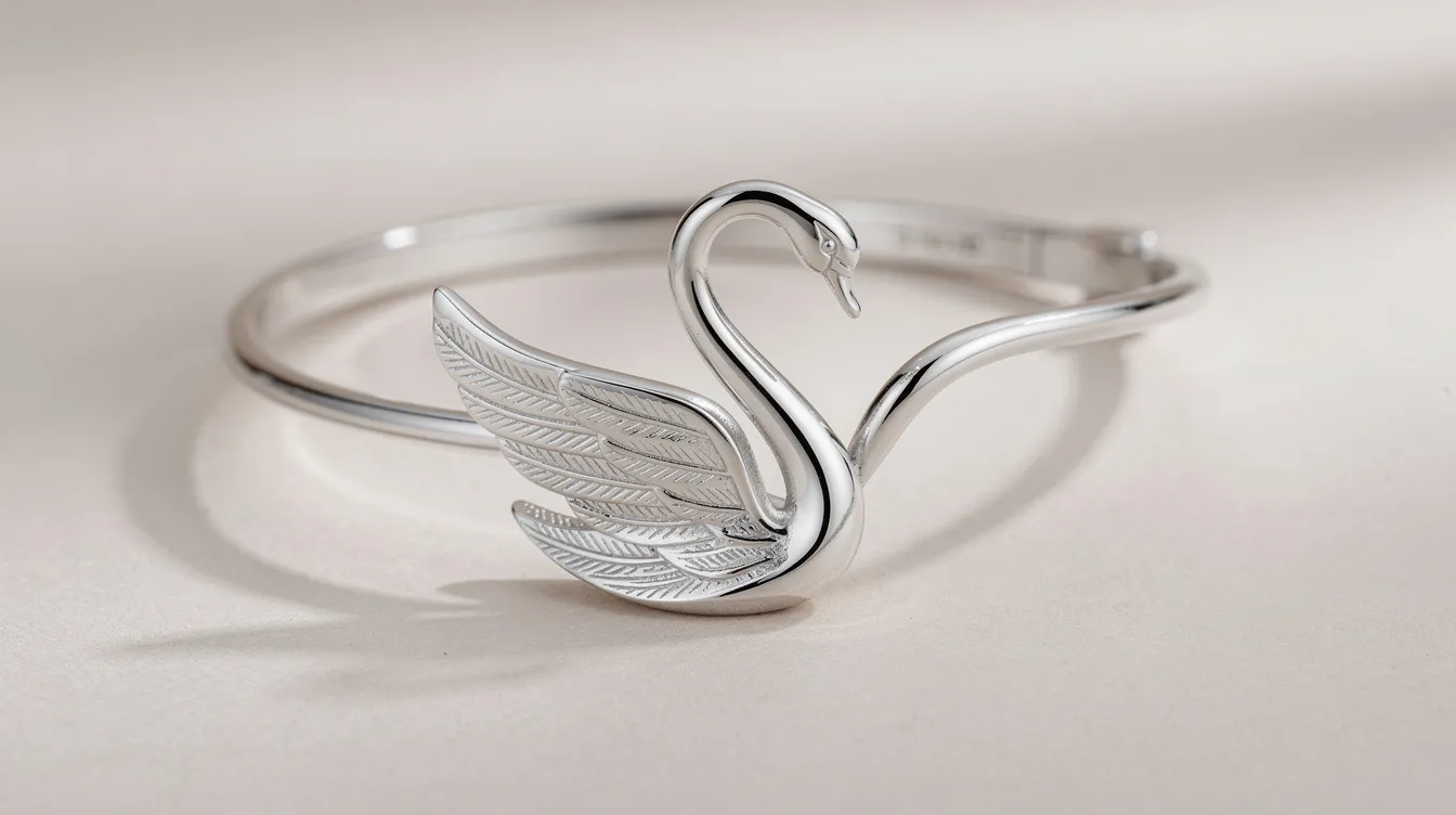 The image features an elegant sterling silver swan bracelet, showcasing a graceful swan motif with a full cut crystal body, embodying sophistication and subtle glamour. This versatile double wrap bracelet is designed with crisp clear pavé lines and an innovative magnetic closure, making it a perfect statement piece for any accessory collection.