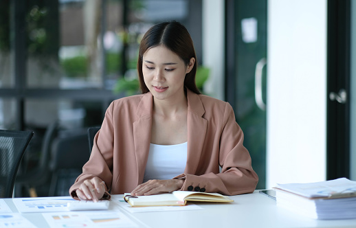 Intelligent woman, happily working on a project alone. 