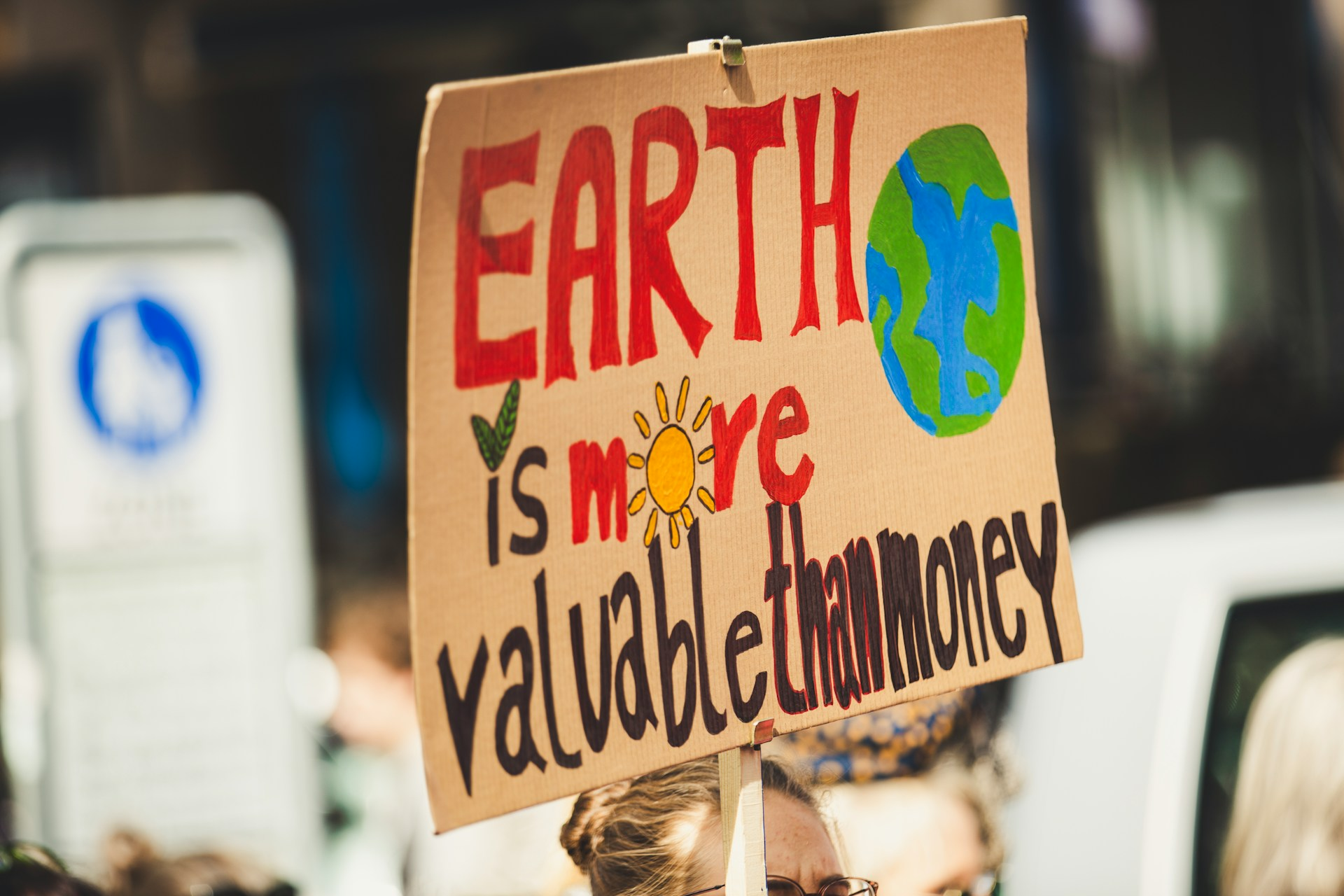 Picture from a climate demonstration, with a sign highlighting the importance of the planet and sustainability. 